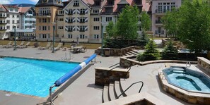 Relax by the pool surrounded by traditional European architecture.