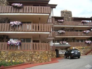 Stunning hotel with a traditional facade, featuring balconies with beautiful floral arrangements and a welcoming entrance.