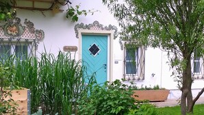 A garden with raised wooden beds, a variety of plants, and purple flowers.