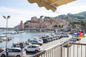 A coastal town with a marina, parked cars, and buildings with a tower. - Studio Rio Marina (Rio)