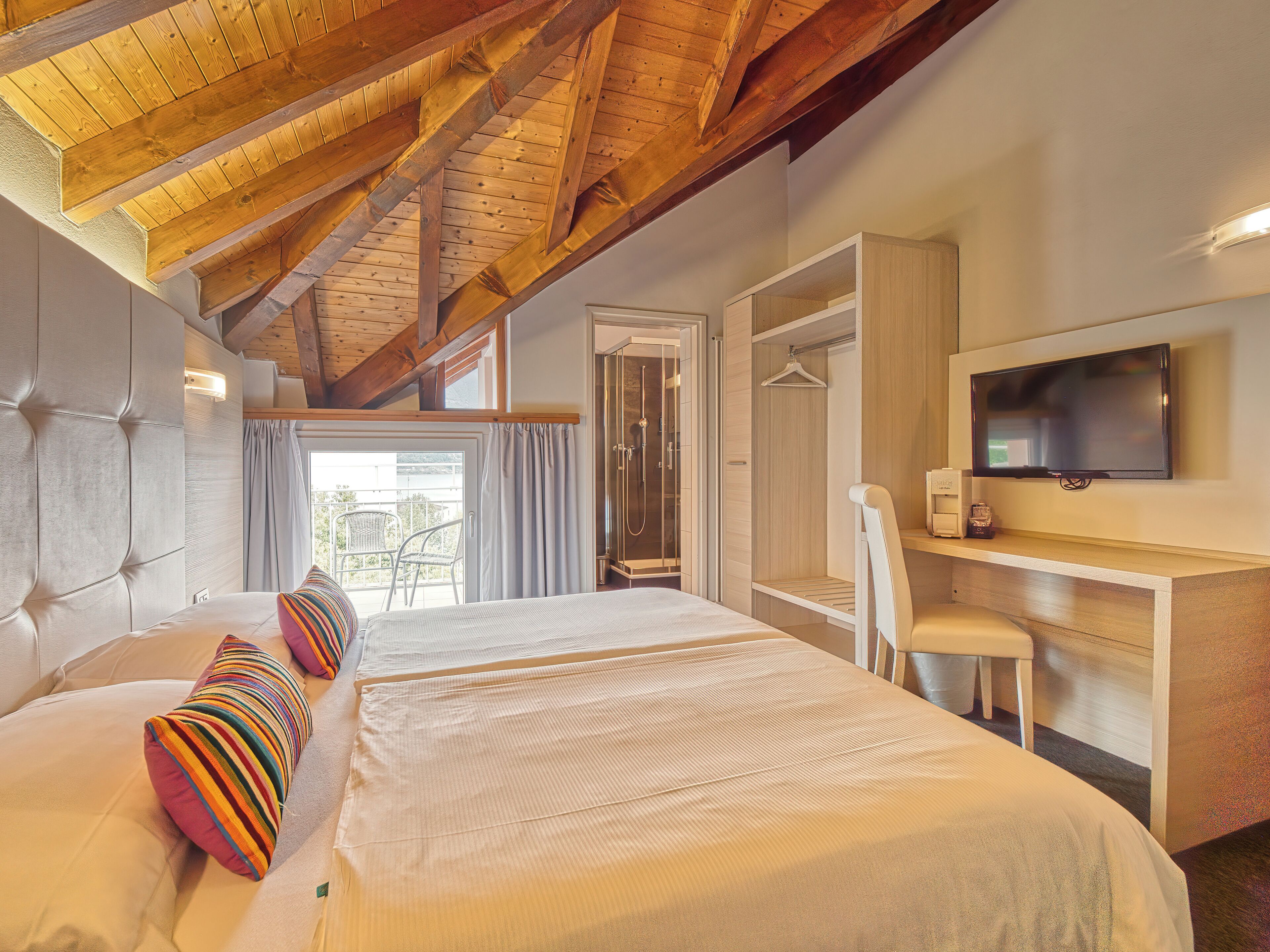 family room, balcony, lake view | down duvets, in-room safe, individually decorated