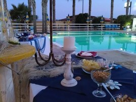 Una piscina al aire libre de temporada, sombrillas