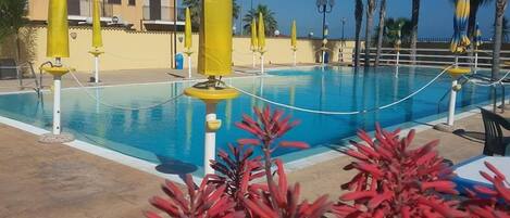Seasonal outdoor pool, open 9:00 AM to 7:00 PM, pool umbrellas