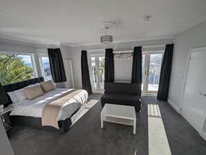 Family Suite, Balcony, Sea View | Desk, laptop workspace, blackout curtains, iron/ironing board