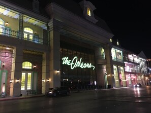 A building with a large illuminated sign reading "The Orleans".