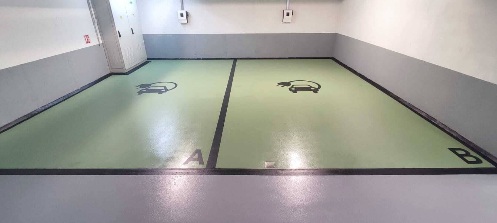 A parking garage with two marked parking spaces labeled A and B.