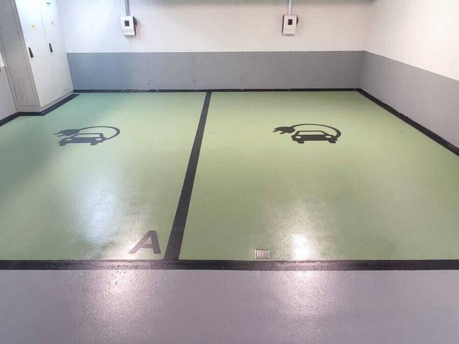 A parking garage with two marked parking spaces labeled A and B.