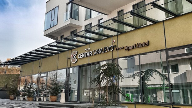 A modern hotel with a glass facade, a prominent sign reading "CENTAR SARAEVO Apart Hotel," and a staircase leading to the entrance. - Aparthotel Centar Sarajevo (Sarajevo)