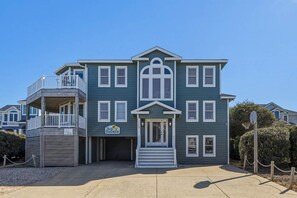 A two-story building with a balcony and a sign that reads 'DUCKER.'