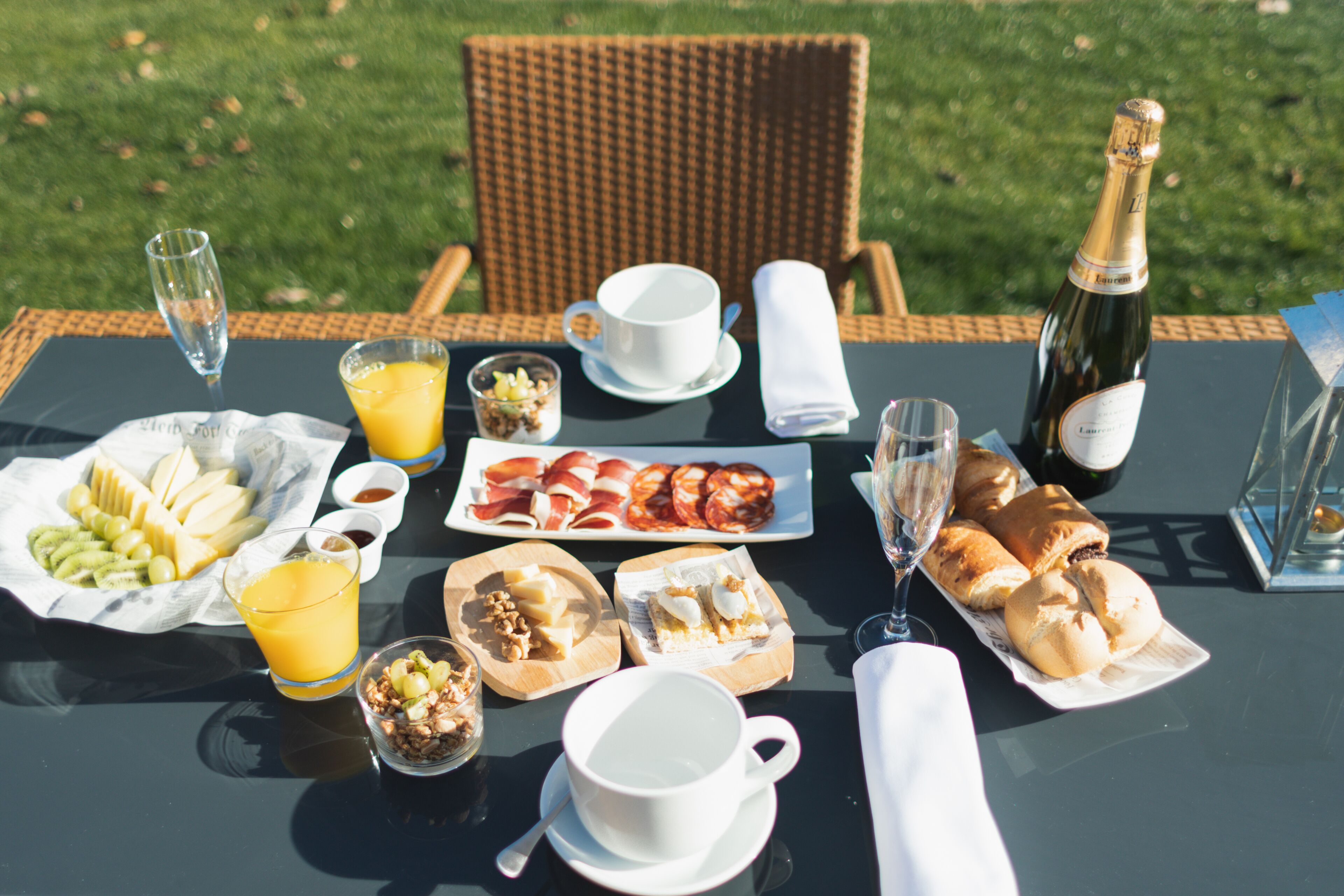 Mesa lista para el desayuno con diversas comidas y bebidas.