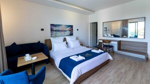 A modern hotel room with a bed, a desk, a chair, a sofa, and a large window. - Mateus hotel (Ghazir)