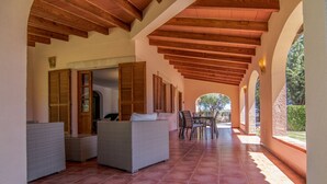 A covered patio with wicker furniture, a dining table, and chairs. -  Quiet family Villa in Pollensa countryside with pool,  just 3 km from town (pollensa)