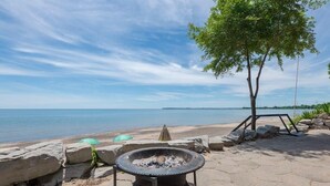 A beachside fire pit area with a view of the water.