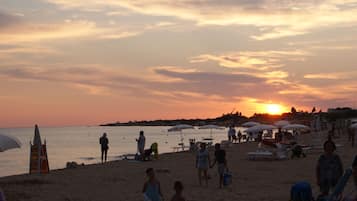 On the beach, sun-loungers