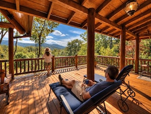 A wooden deck with a view of a mountainous landscape.