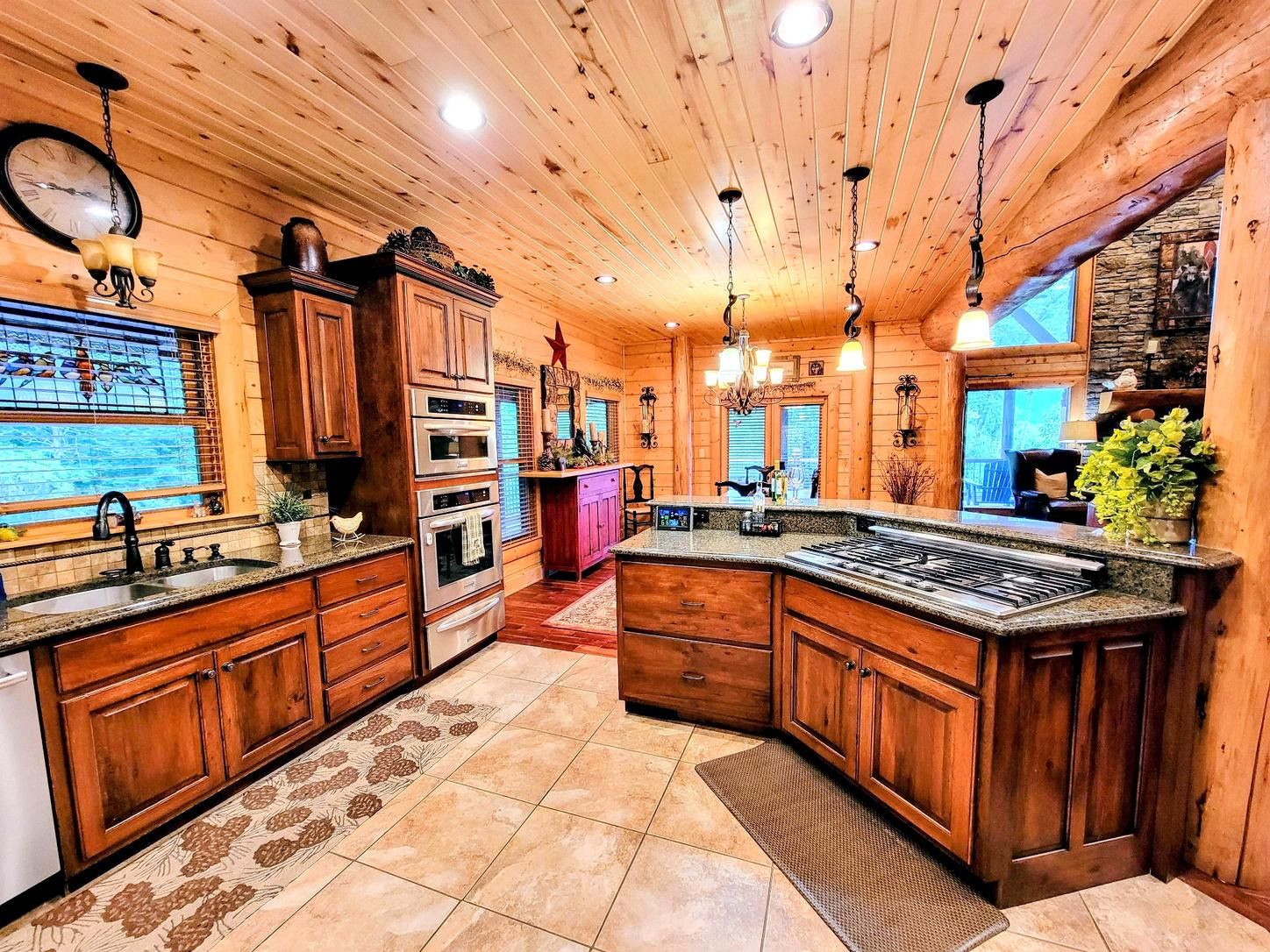 A kitchen with wooden cabinets, a central island, and built-in ovens.