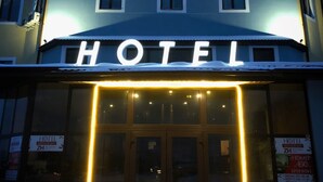 A hotel with illuminated signage reading "ZHULANY CITY HOTEL" and a digital display board outside. - Hotel & Restaurant Zhuliany City (Sofiivska Borschahivka)
