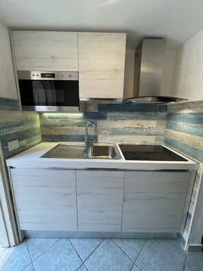 Fridge, microwave, cookware/dishes/utensils, dining tables