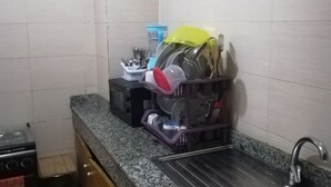 A kitchen with a granite countertop, stainless steel sink, and a dish rack with utensils. - PRETTY T3 EQUIPPED COCODY (Cocody)