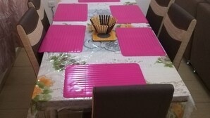 A dining area with a table set for four, surrounded by chairs. - PRETTY T3 EQUIPPED COCODY (Cocody)