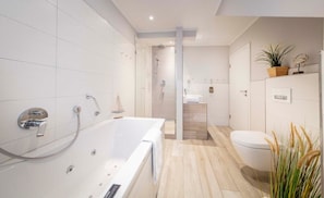 Bathtub, jetted tub, hair dryer, towels