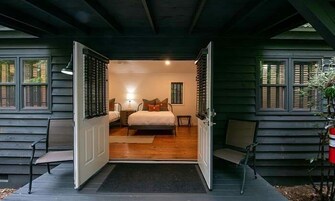 A bedroom with a bed, bedside tables, and a nightstand.
