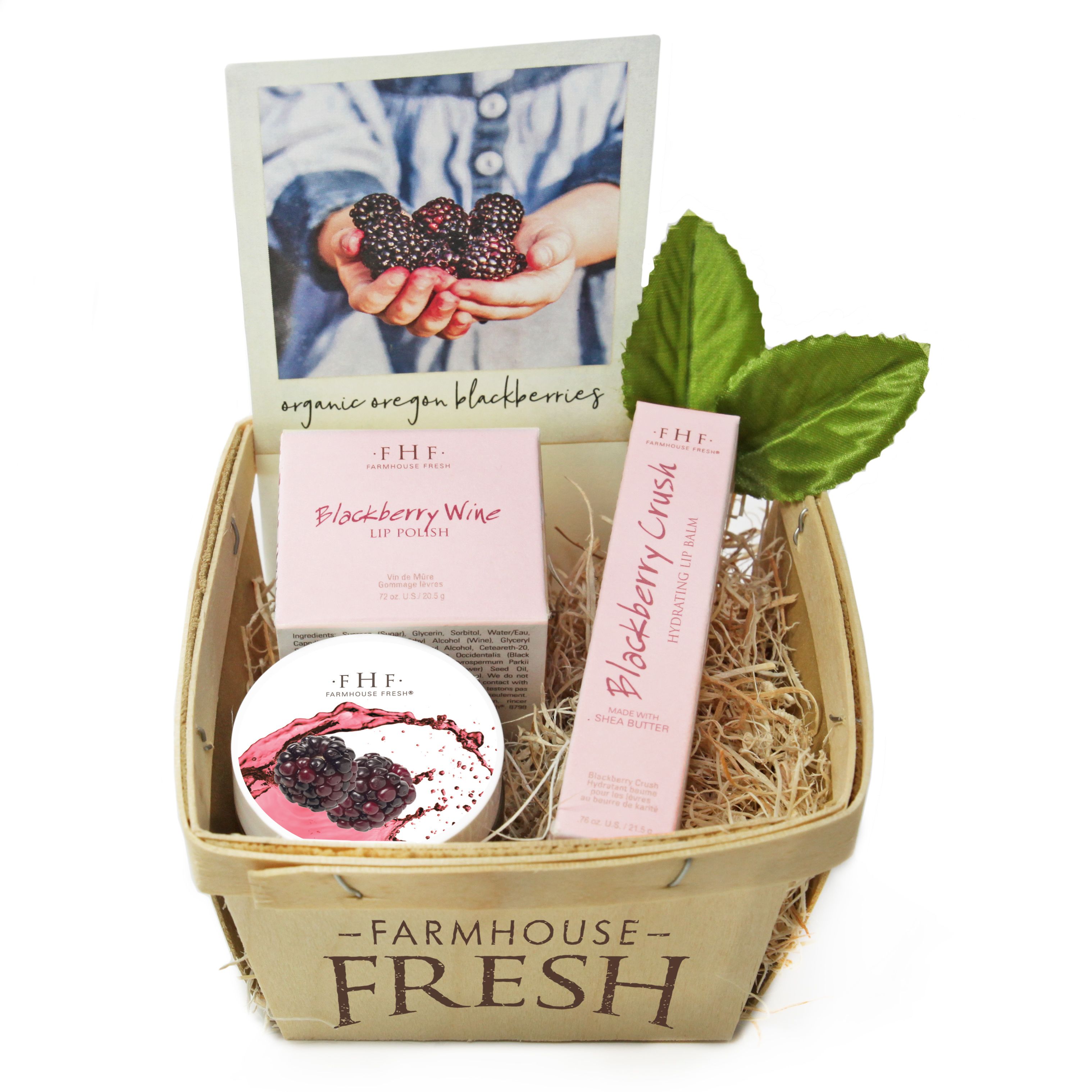A gift box labeled 'Farmhouse Fresh' containing a lip polish, a hydrating lip balm, and a jar of blackberry wine.