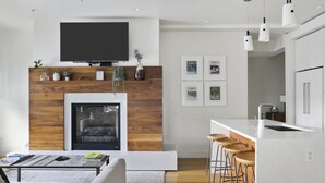 A modern kitchen with white cabinets, a built-in oven, and a stainless steel sink. - Outpost: One Town Hill 507 - Base of Snow King Mtn (Jackson)