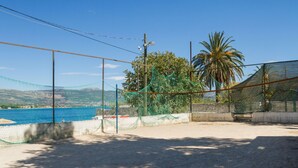 A fenced area with a view of a body of water and hills in the background. - ARBANIJA A2, budget 1-bedroom apartment, 80m from the beach (Arbanija)