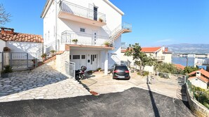 A two-story building with a stone staircase leading to a gated entrance. - ARBANIJA A2, budget 1-bedroom apartment, 80m from the beach (Arbanija)