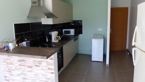A compact kitchen with a microwave, coffee maker, and a small refrigerator. - GITE VERY COMFORTABLE IN THE COUNTRY, NICE VOLUMES PROMOTION IN JULY (Cours-de-Pile)