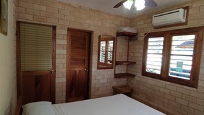 A bedroom with a bed, a ceiling fan, a window, and an air conditioning unit. - Casa Leyani y Osvedy (Viñales)