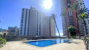 A rooftop pool with a clear view of surrounding high-rise buildings.