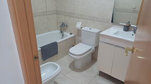 Bathtub, hair dryer, towels, soap