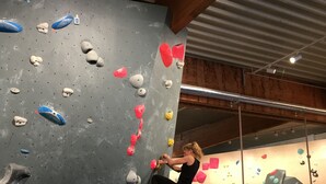 An indoor rock climbing facility with various colored holds and a climber in action. - Original holiday in the westcoast STORE in Friedrichstadt / North Sea for 2-4 P.  (Friedrichstadt)