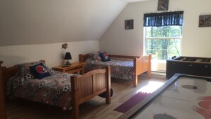 A room with two wooden beds, a pool table, and a window with curtains. - All Star Acres 2 Miles To Park
5 BR,3 baths
 Dates align with Dreams Park ONLY! (Milford)
