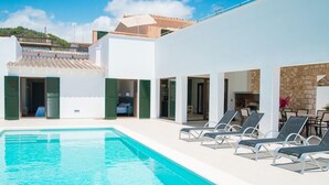 A modern pool area with clear blue water, white walls, and green shutters. - Ferrer de Shorta Modern holiday home for 10, private pool, A/C and Wi-Fi (S'Horta)