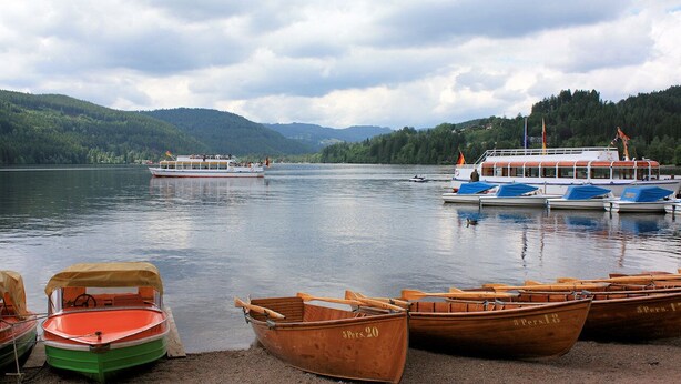 A lake with boats, including a large ferry and several rowboats. - House right on the edge of the forest, right at the foot of the Black Forest  (Schopfeim Ortsteil Enkenstein)