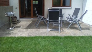 A patio with outdoor furniture, a grill, and a sliding glass door leading to an interior space. - House right on the edge of the forest, right at the foot of the Black Forest  (Schopfeim Ortsteil Enkenstein)