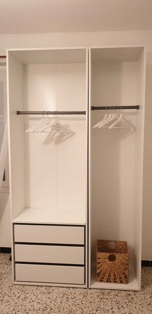 A white wardrobe with a hanging rod and a drawer unit. - La Managerie at Alice's place, Ardechoise house type (Lablachère)