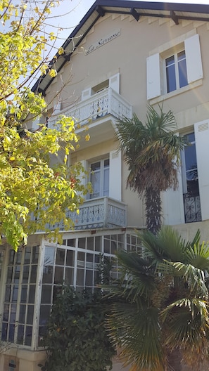 Enjoy the charming balcony with ornate railings and a sign reading 'La Savane'.