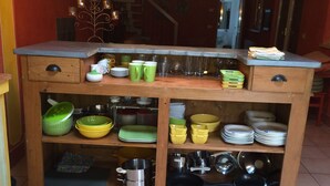 A kitchen with wooden cabinets, shelves, and a countertop. - chaming little house with pool facing the most  beautiful tuscan scenary  (Lucca)
