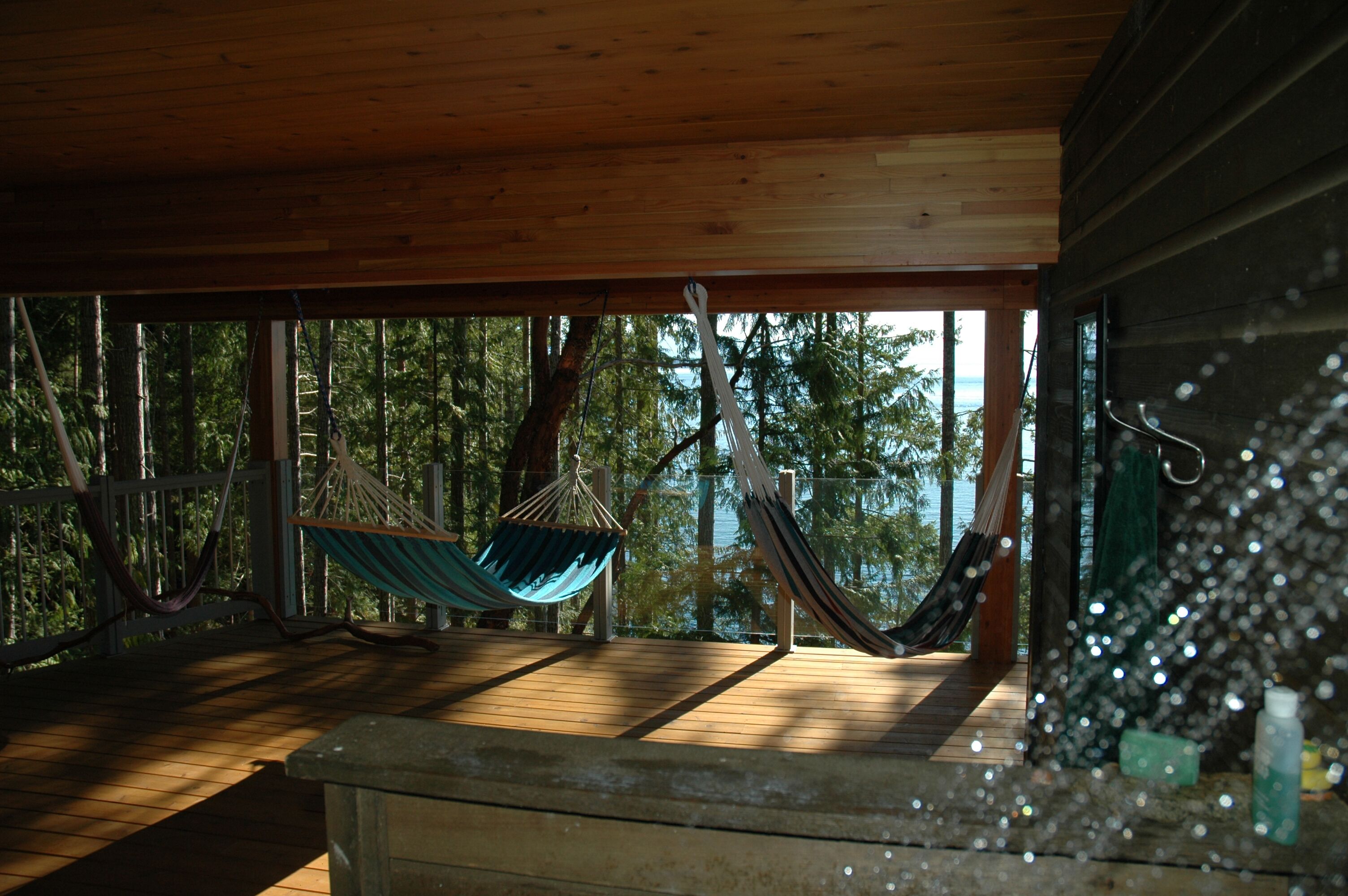 Outdoor shower on lower deck with ocean view.
