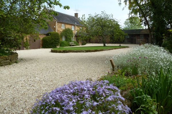 The cottage in summer. There is now a new tree in the middle.