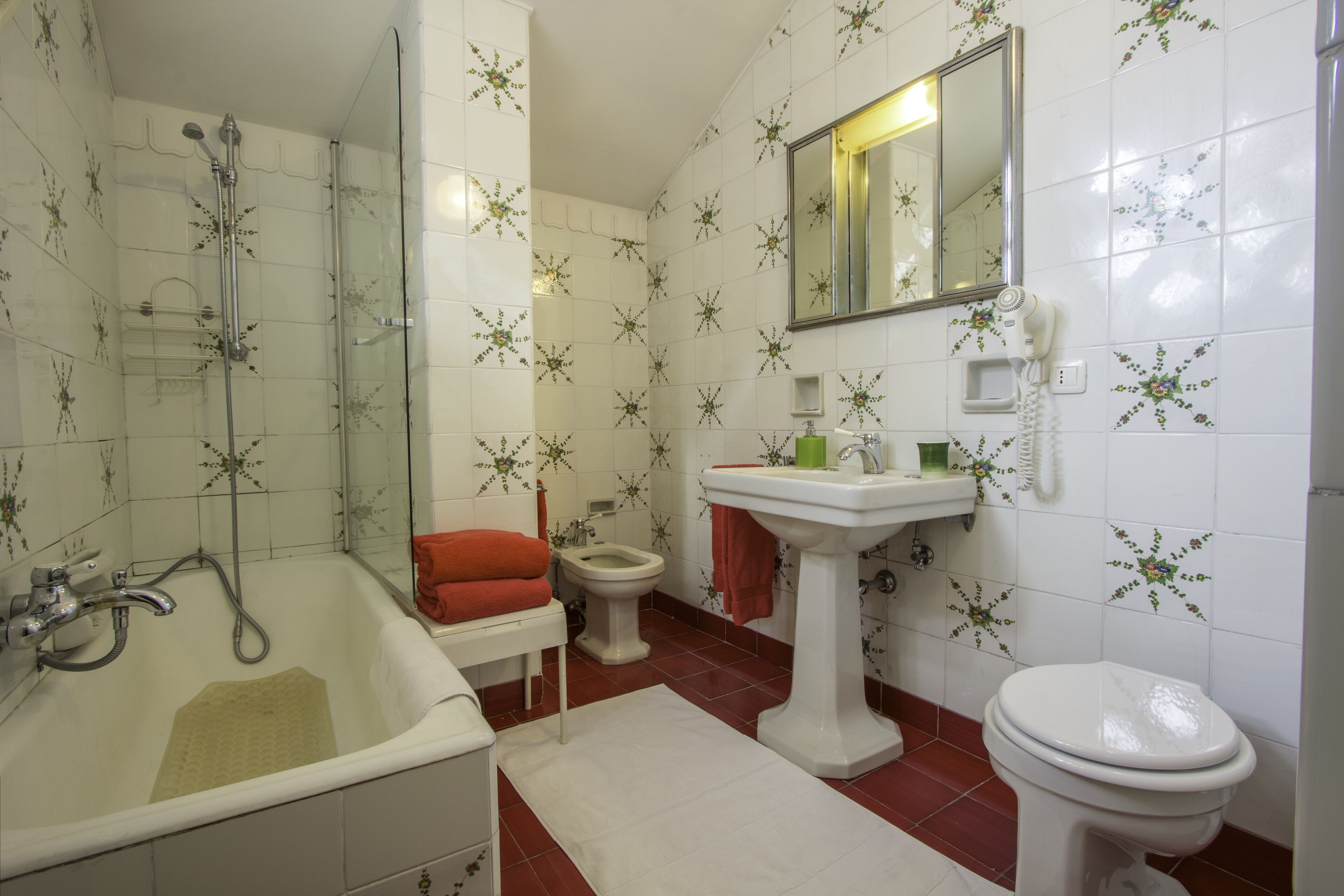 A bathroom with a bathtub, toilet, and sink.