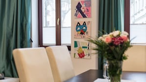 A dining area with a table, chairs, and artwork on the wall. - Family-friendly 3-room apartment in the middle of hip Pieschen (Dresden)