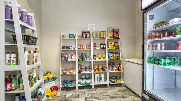 A small convenience store with shelves stocked with snacks, drinks, and household items.