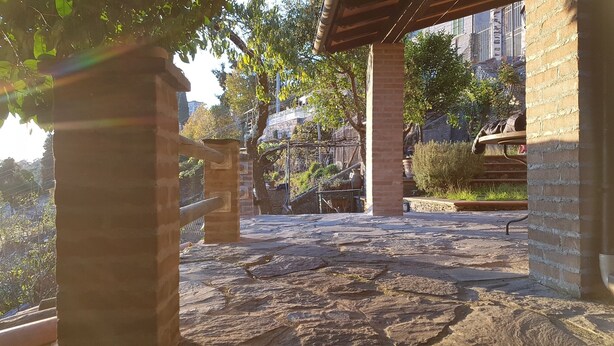 A stone pathway leading to a covered area with brick walls and a metal railing. - DELICIOUS RUSTIC WITH PRIVATE GARDEN AND TERRACE A FEW KM. FROM THE SEA.  (Retignano)