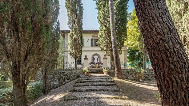 A stone staircase leading to a building with a tiled roof, surrounded by tall trees. - Apartment in Country Villa and  SPA (Vicchio (Firenze))