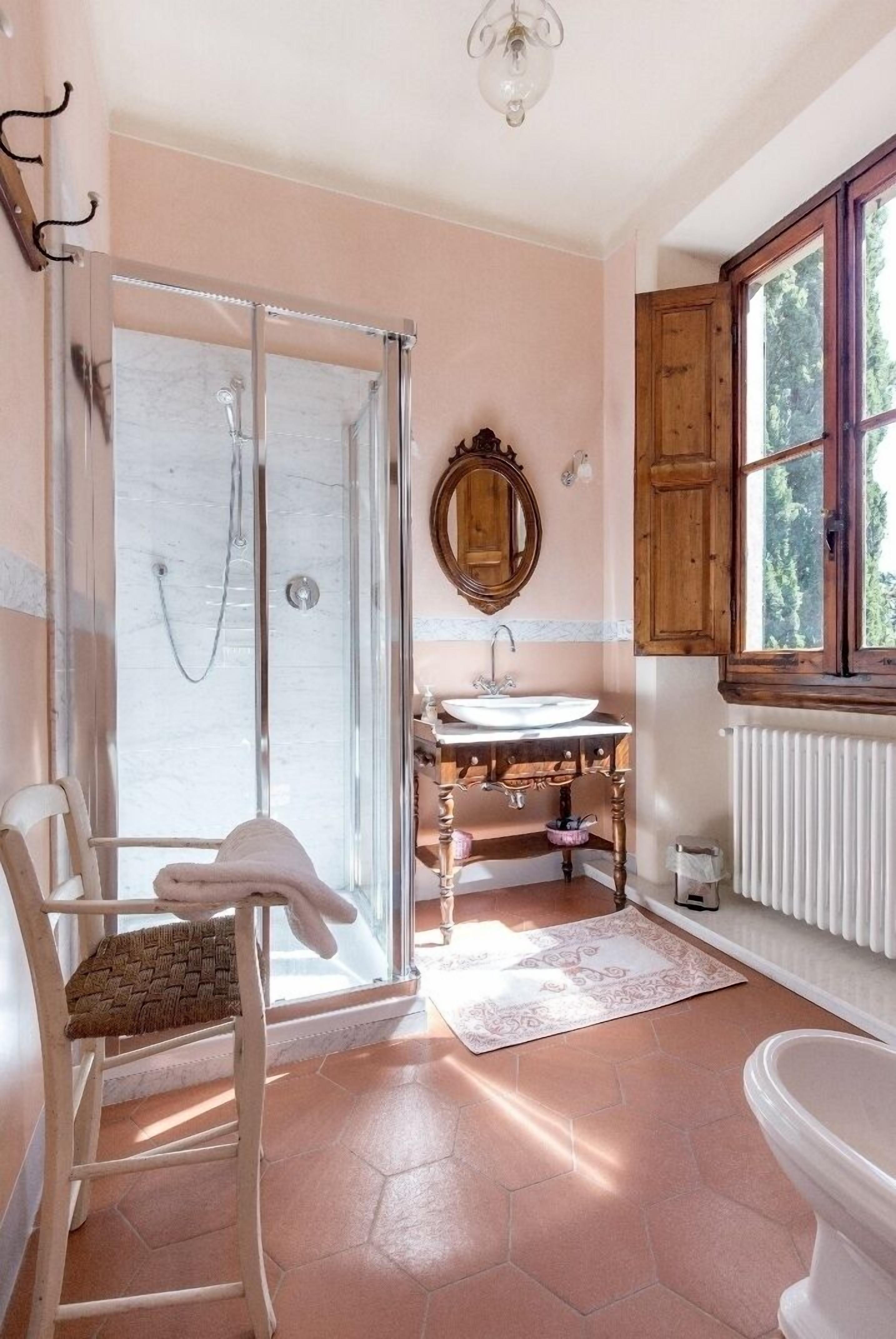 A bathroom with a shower, sink, and toilet.